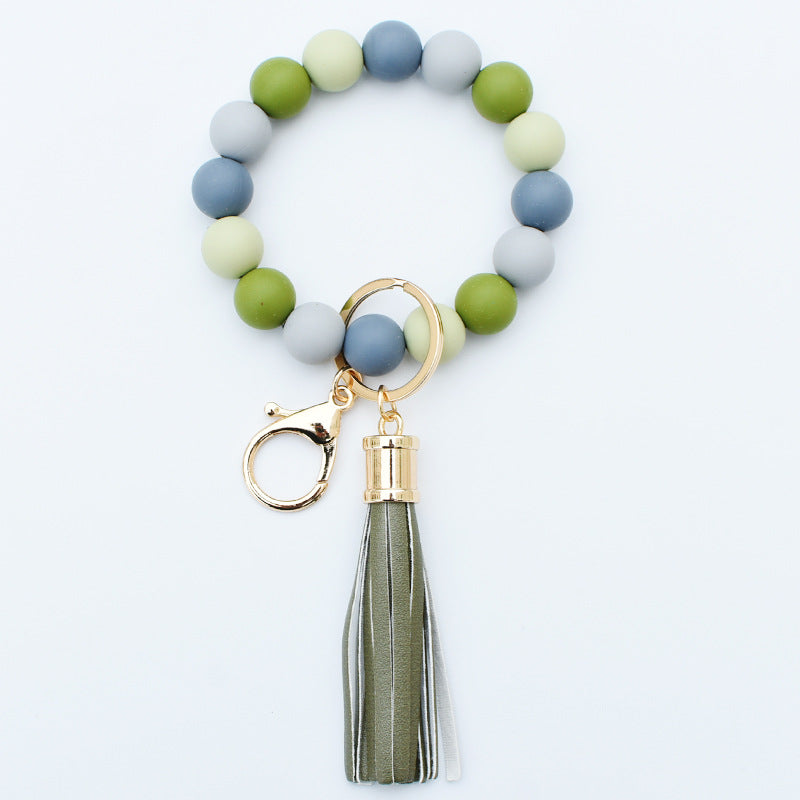 Llavero al por mayor de la muñeca de la borla de la PU del grano del silicón